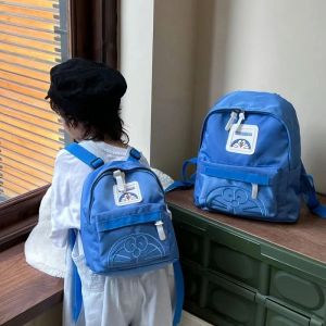 Çantalar Doraemon İlkokul öğrencileri için okul çantası hafif küçük sırt çantası düz renkli karikatür anaokulu bebek moda sırt çantası
