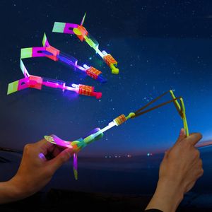 LED SwordsGuns 10pcs LED Flying Toys Outdoor Shining Rocket Flashing LED Light Slings Elastic Helicopter Rotating Flying Toys Christmas Gift 230323