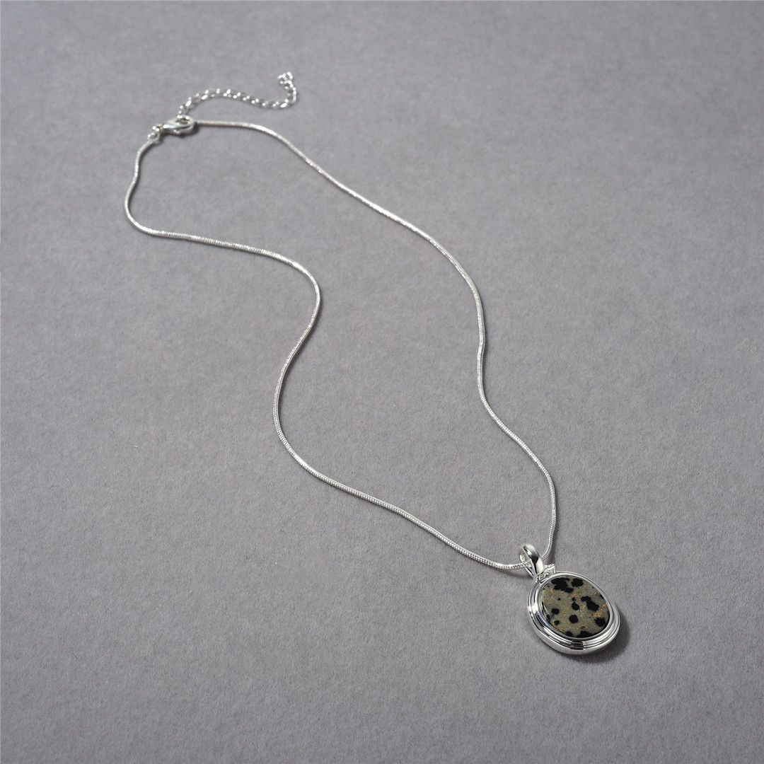 A spotted stone pendant necklace