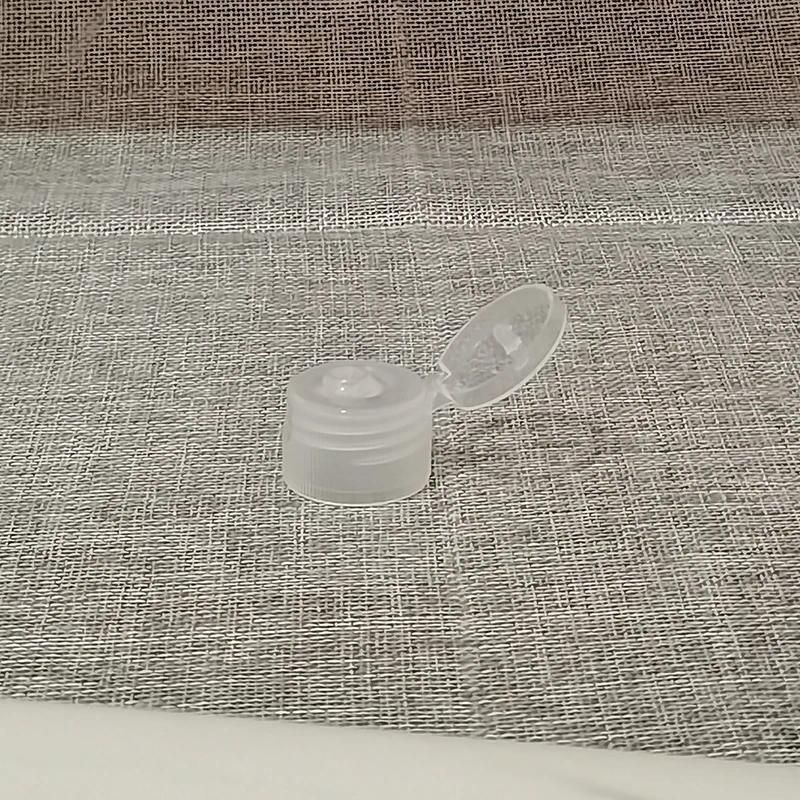Weiße Kunststoffflasche mit transparentem Klappdeckel