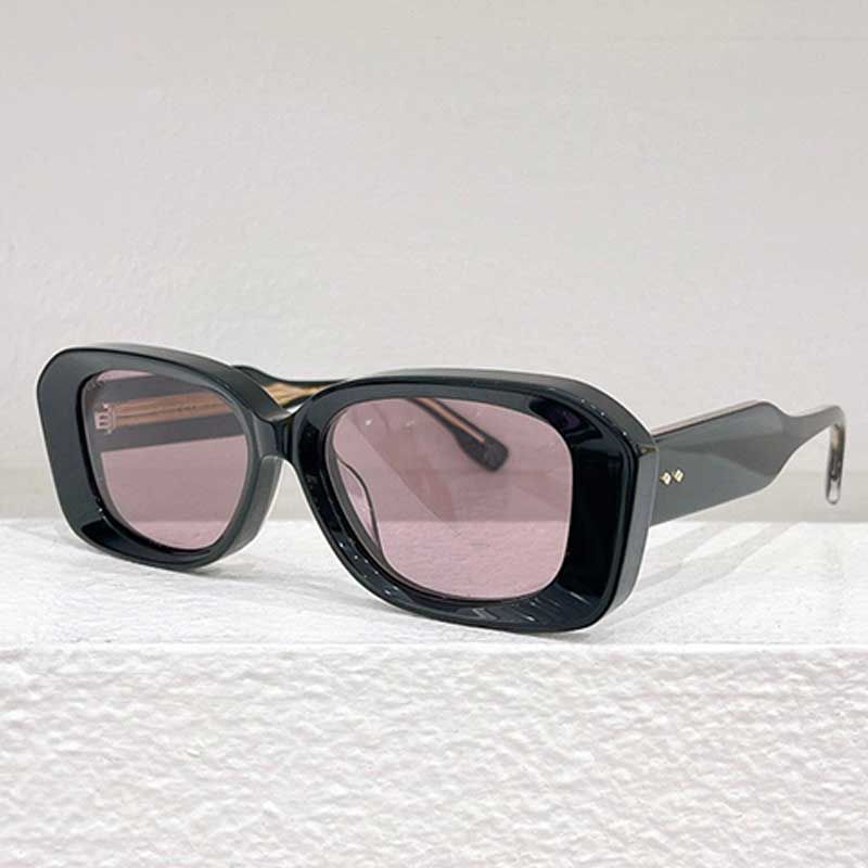 Black framed pink lenses