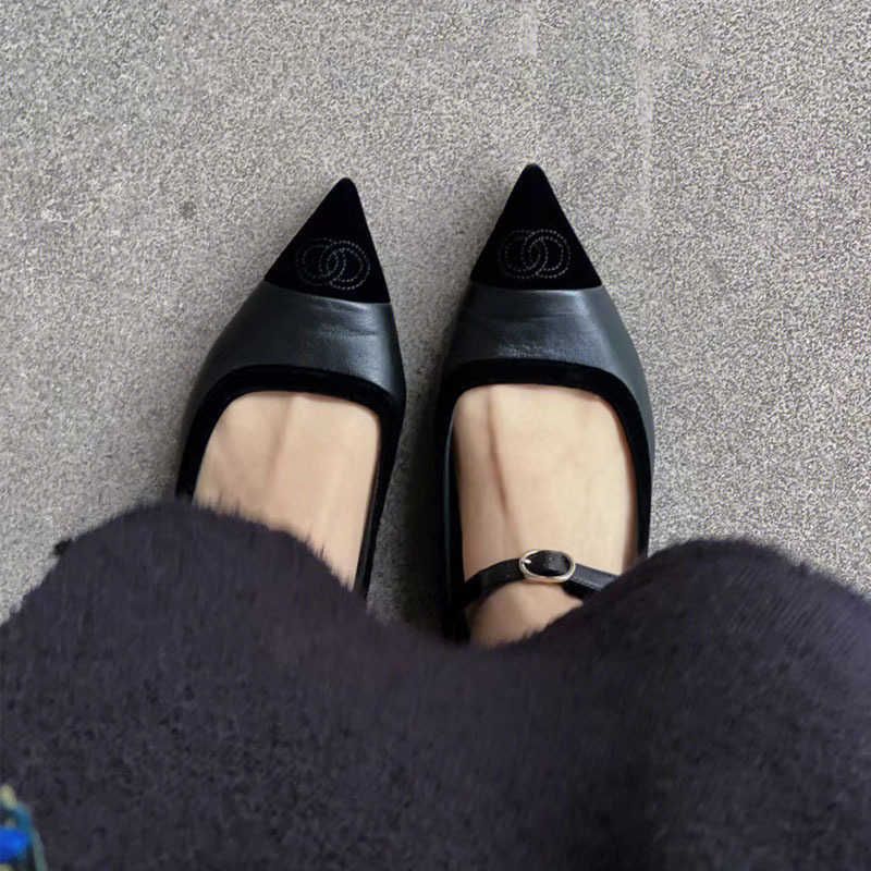 黒い尖った平らな靴