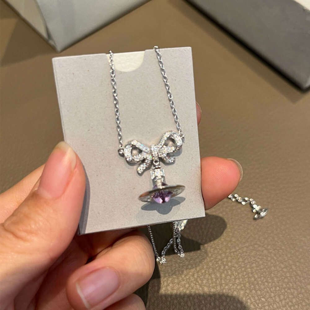 Collier planète en argent avec nœud boule violet