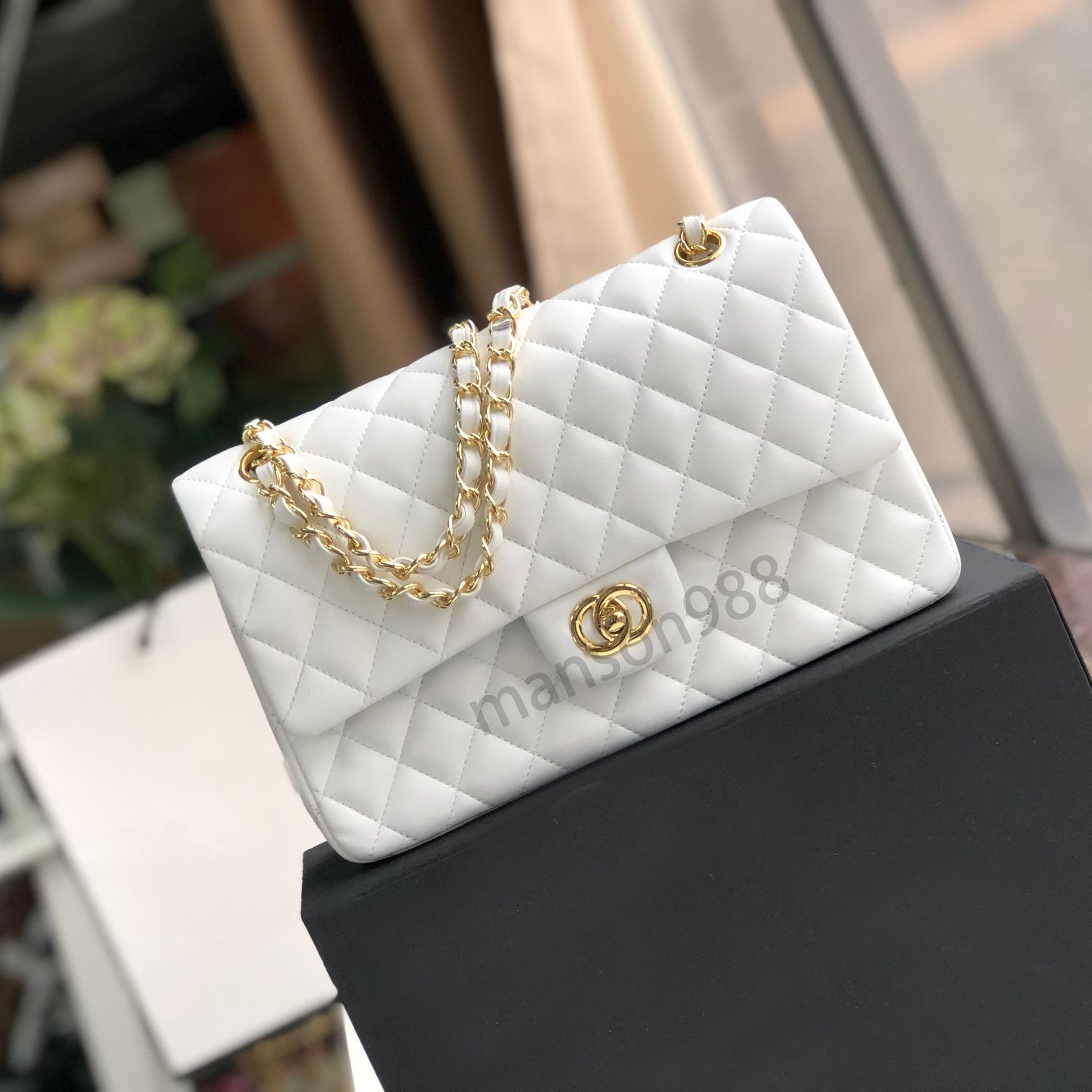 white bag with gold buckle