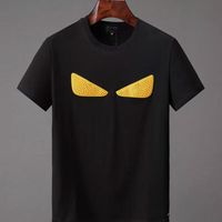 Camisetas de diseñador para hombres algodón puro manga corta monstruo ojos amarillos patrón de la calle parejas de camiseta casual suelta tops camisetas