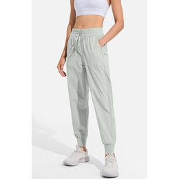 "Comfortable and Stylish Women's Jogging Yoga Pants with Pockets - High Waist, Hip Lift, Elastic, and Drawstring Legs for Casual and Fitness Activities"