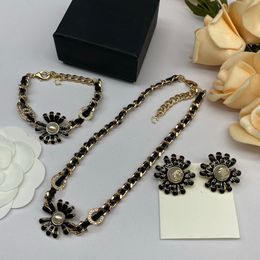 Leather twisted piece brass chain necklace water diamond flower pendant copper material black sheepskin thread bracelet camellia pearl earrings Jewelry