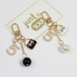 Key Rings Luxury Handbag Pendant Keychains Fashion Pearl Number 5 Tassel Keyrfor Women Bag Ornament Car Key Chains Jewellery Accessories J240108
