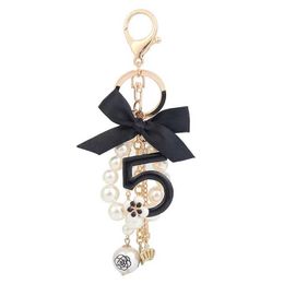 Key Rings Number 5 Camellia Bag Pendant For Woman Luxury Jewellery Bow Car KeyrBowknot Camellia Pearl Keychains Bag Decoration J240108