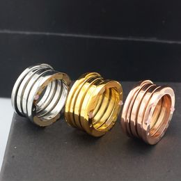 Designer de luxo 18k anel de ouro primavera aço inoxidável prata rosa ouro anel de moda para amantes branco preto anel de casal de cerâmica para mulheres homem jóias presente