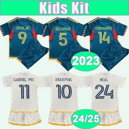 2023 LA Galaxy Kids Kit Soccer Jerseys 24 25 FAGUNDEZ RIQUI PUIG JOVELJIC CUEVAS CERRILLO AGUIRRE AUDE BRUGMAN Home Away Football Shirts