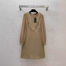 2024 Spring Black / Khaki Solid Color Panelled Dress Long Sleeve Round Neck Buttons Knee-Length Casual Dresses B4M181407