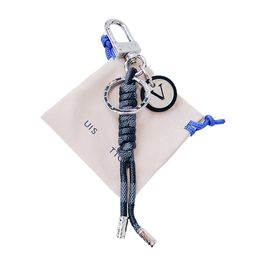 Louiseviution keychain is fashionable and playful The Damier canvas round logo looks exquisite and is decorated with rope knots and ribbon trims M67224