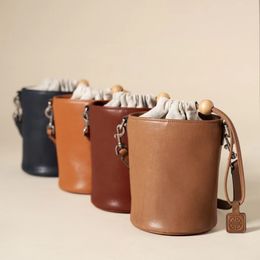 Original drawstring bucket bag, female vegetable tanned leather niche bag, retro texture, one shoulder crossbody bag, round bead personality tote