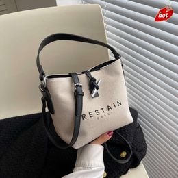 Factory Source High Quality Handbags Is 2024 Fashion Personality Daily Commuter Canvas Letter Printing Cow Horn Buckle Simple Bag One Shoulder Crossbody