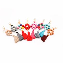 Wholesale of new cross-border beaded pendants, bag pendants, women's accessories, creative solid color wood bead tassel keychains