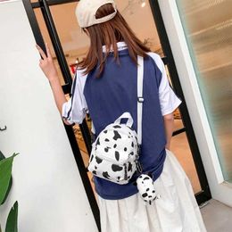 Backpacks Mini canvas day bag with plush pendant and cow print backpack suitable for women girls outdoor travel and shoppingL2405