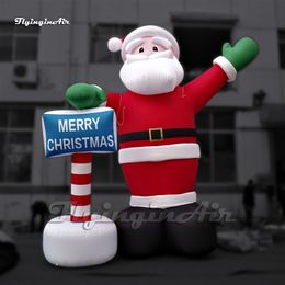 Atacado Amazing Red Giant Giant Inflável Santa Pai natal Figura Modelo de ar São Saint Nicholas segurando uma placa para a decoração de Natal ao ar livre