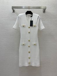 2024 Summer White / Black Solid Color Panelled Knitted Dress Short Sleeve V-Neck Buttons Short Casual Dresses B4W021414