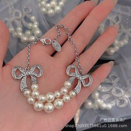 Designer Westwood Double Layer Pearl Inlaid Diamond Bow Knot Saturn Bracelet New INS Sense