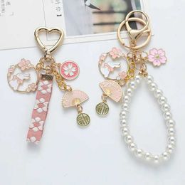 Keychains Lanyards Korean Sweet Cherry Blossom Rabbit Keychain Womens Creative Ribbon Pearl Keychain Handbag Headphone Box Pendant Jewellery J240509