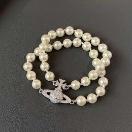 Brand Westwood Double Layer Pearl Saturn Magnetic Buckle Bracelet Womens Classic Diamond Planet Nail