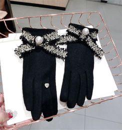 South Korea new style pearl raw edge bowknot cashmere warmth and thick fivefinger touch screen gloves female autumn and winter fi1313297