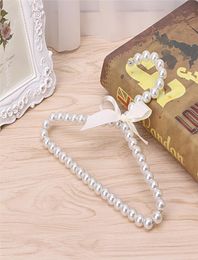 Whole 10 PCS Fashion Plastic Pearl Beaded Bow Baby Clothes Hangers Storage Dry Rack 3712181
