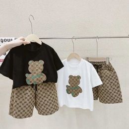 Clothing Sets Childrens clothing boy summer cartoon bear T-shirt and checkered shorts 2-piece set geometric track set teenage girl three-dimensional bear d240514