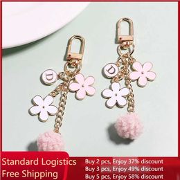 Keychains Lanyards Fashionable Metal Flower Fur Ball Pom Letter Keychain Womens Pink Headphone Case Pendant Key Bag Decoration Y240510