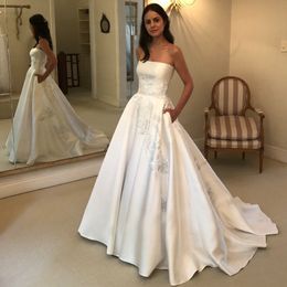 Stunning Lace Appliqued Wedding Dresses With Pockets Bridal Gowns Strapless Neckline A Line Sweep Train Satin Vestido De Novia