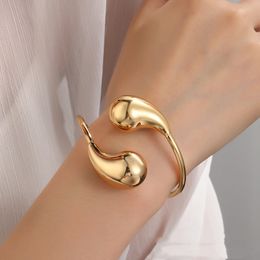 European and American stainless steel hollow smooth water droplet bracelet made of titanium steel material, spring wire, gold comma opening bracelet