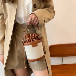 Womens shoulder bag cylindrical PU leather bucket womens cross shaped bag casual handle bag summer travel shopping handbag 240517