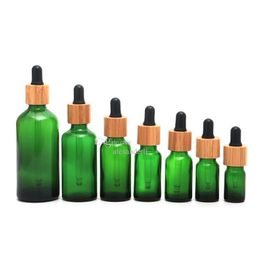 Packing Bottles Wholesale Frosted Green Glass Dropper Bottle 5Ml 10Ml 15Ml 20Lm 30Ml 50Ml 100Ml With Bamboo Lid Cap 1Oz Wooden Essen Dhbjp