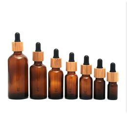 Packing Bottles Wholesale Frosted Amber Glass Dropper Bottle 5Ml 10Ml 15Ml 20Lm 30Ml 50Ml 100Ml With Bamboo Cap 1Oz Wooden Essential Dhidi