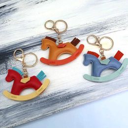 Keychains Lanyards New fashion designer PU leather rocking horse keychain small pendant decoration womens bag charm accessories Q240521