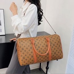 Designers Duffel Bags 55CM luxury large capacity travel sale women men pu Leather shoulder Fashion bag carry rivets with lock Black Embossed Letter