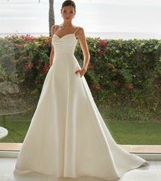 Eleganti abiti da sposa in raso a V-Neck a Ivory con tasche con cinturini spaghetti a-line perenne pieghe