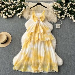 Summer outfit for women on vacation taking photos of long dresses with French high-end feel waist cinched ruffle edge patchwork suspender dress
