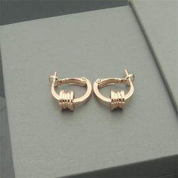 Small waist earrings temperament personality half coil spring titanium steel couple earrings brand with the same ear fashion ins