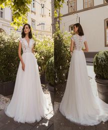 2020 Bohemian ALine Wedding Dresses V Neck Capped Sleeves Lace Appliques Bridal Gowns Button Back Sweep Train Garden Wedding Dres3184715