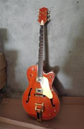 Real Pos Orange Body Electric Guitar with Golden hardwareTremolo bridgecan be customized4979252