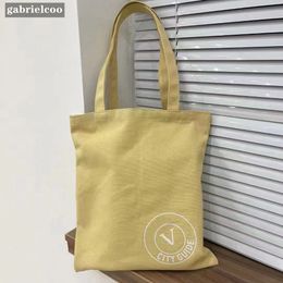 Designer Exhibition Yellow Canvas Bag Classic Logo Printed Canvas Bag Fashion INS Minimalist Tote Bag Environmental Protection Bag Shopping Bag