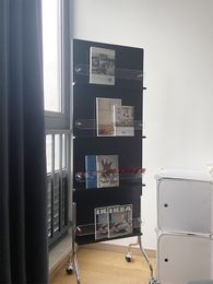 Vintage solid wood magazine, newspaper rack display, bookshelf floor-to-ceiling shelf with wheels, antique storage, photography