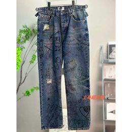 High quality designer clothing Spring/Summer Network Red Product Street Graffiti Tear Hole Jeans Mens Womens Pants