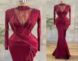 2023 Sexy Prom Dresses Burgundy Dark Red High Neck Long Sleeves Mermaid Illusion Sweep Train Crystal Beading Plus Size Evening Gow4235549