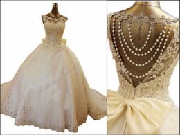 2019 New Bling Crystal Wedding Dresses Scoop Appliques Beads Backless Pearl Bows Ball Gown Court Train Lace Tulle Luxury Custom Br5243469