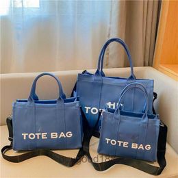 Designer Women's Mc Tote bag Hebei Baigou Luggage Canvas Handheld Bag 2024 New Type Solid Colour Printed Letter One Shoulder Crossbody