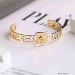 18k Golden Titanium Steel Fan Family Mud Diamond Great Wall Pattern Three Dimensional Beauty Head Open Bracelet for Men and Women