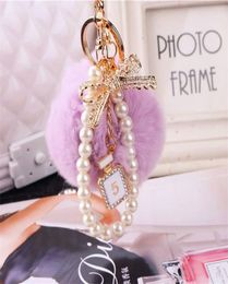 2020 Fashion Pearl Chain Crystal Bottle Bow Pompom Keychain Car Women handBag Key Chain Ring y Puff Ball Keychains Jewelry8794569